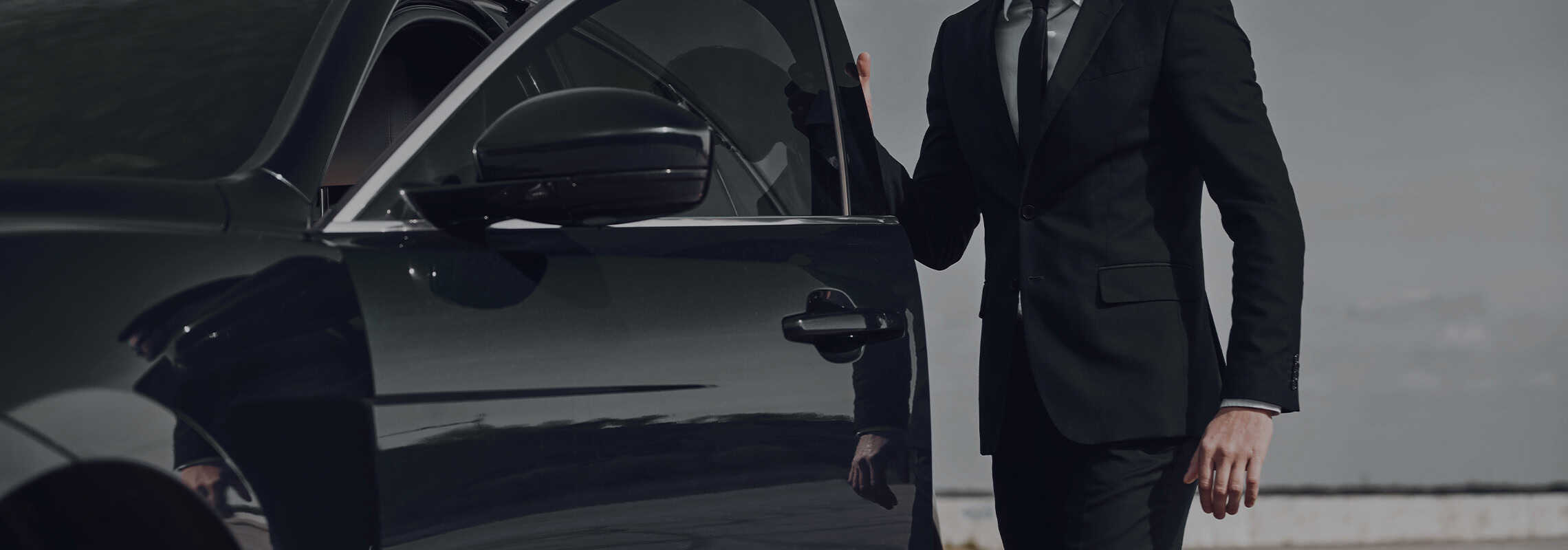 Smiling businessman talking on mobile phone in interior of business car. Luxury Carleone limousine service in Bangkok Thailand offering premium car rental and airport limousine options for traveling comfortably around the city.