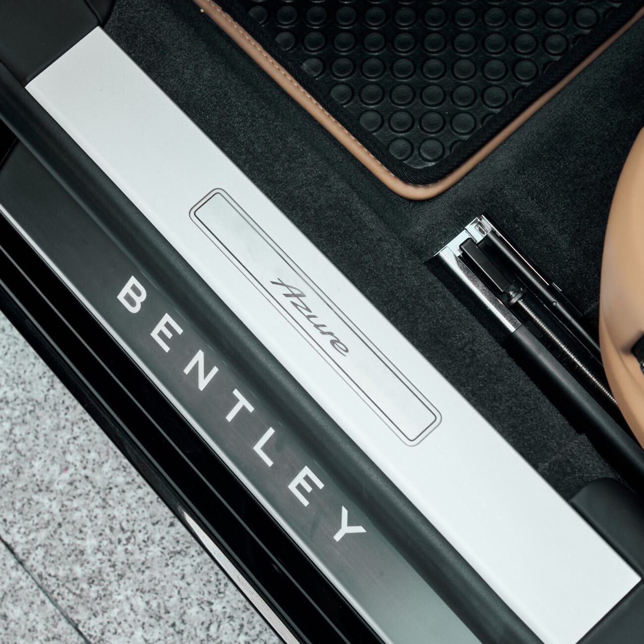 Luxurious Carleone Bentley car door sill with brand logo, located in Bangkok, Thailand, showcasing premium luxury car rental and limousine services including airport transfers.