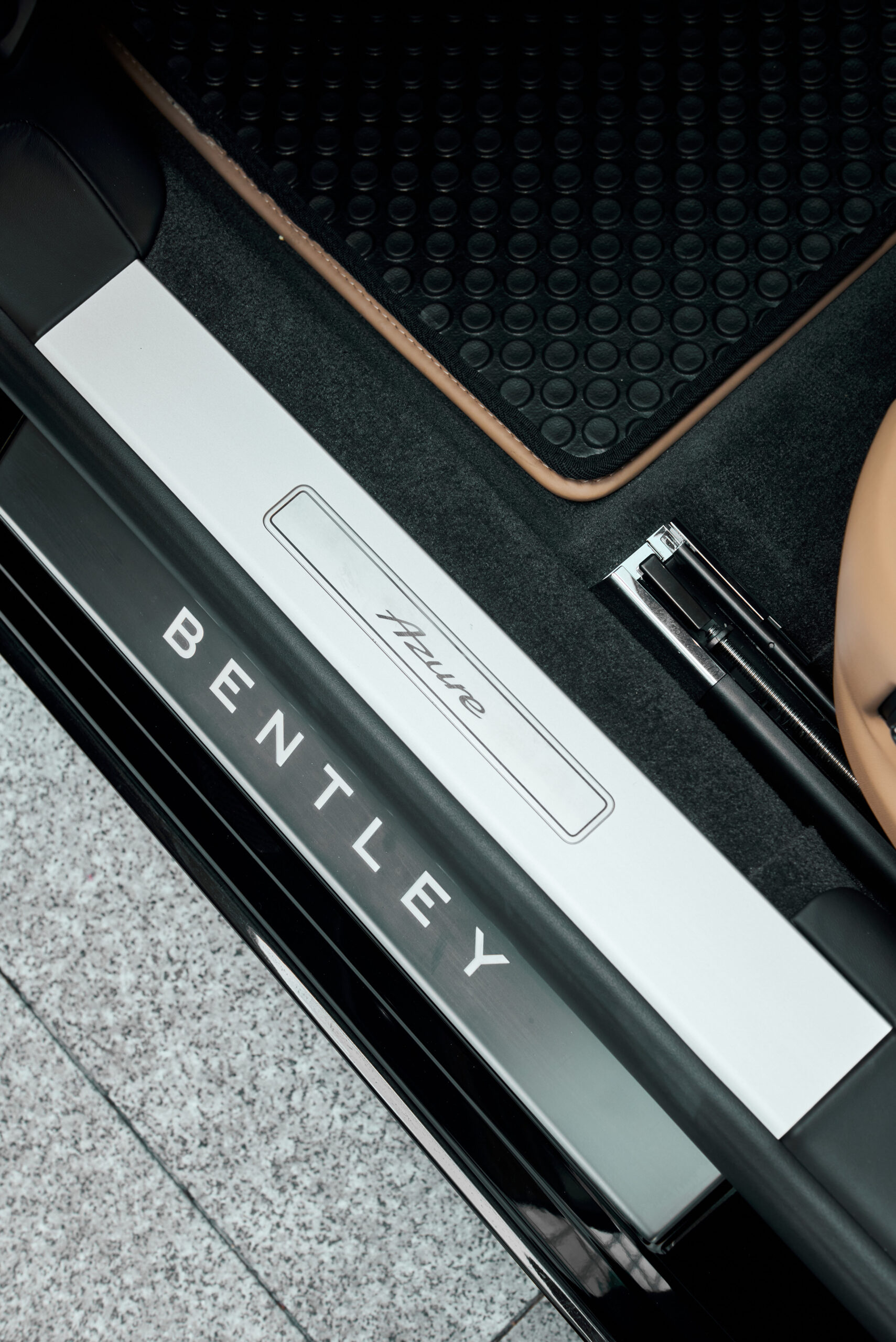 Luxurious Carleone Bentley car door sill with brand logo, located in Bangkok, Thailand, showcasing premium luxury car rental and limousine services including airport transfers.